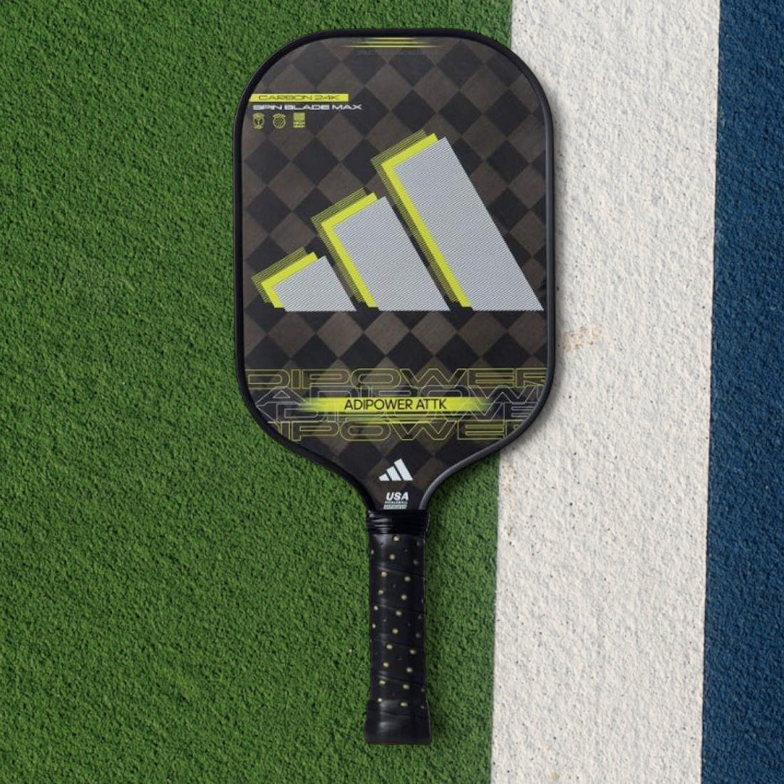 padelpickleball.store adidas Adipower Attk pickleball paddle with 24K carbon fiber and yellow accents on a court