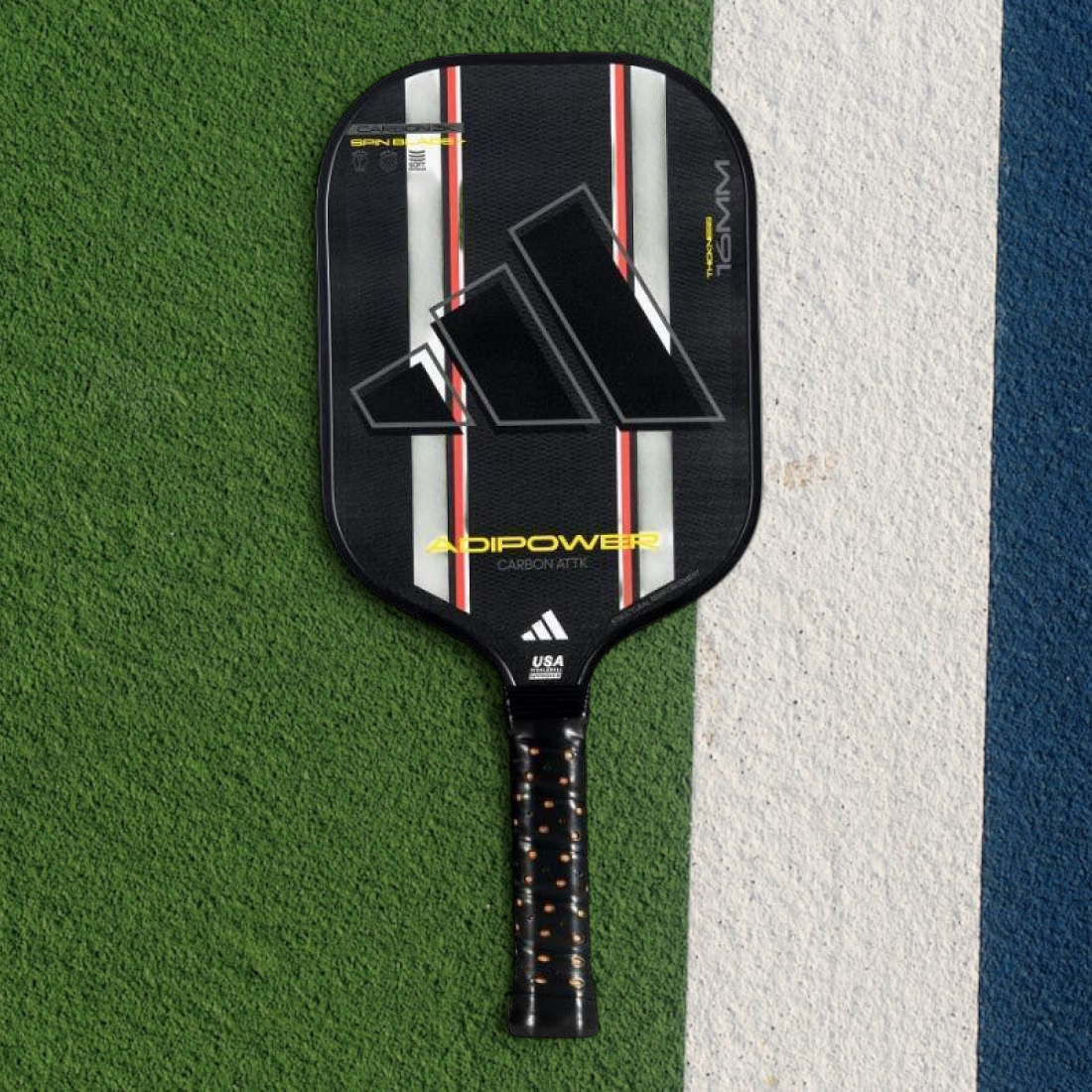 padelpickleball.store adidas Adipower Carbon pickleball paddle in black with red and white accents on a court surface