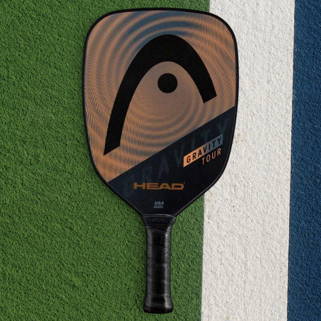 padelpickleball.store HEAD Gravity Tour pickleball paddle with a textured hybrid surface on a green court